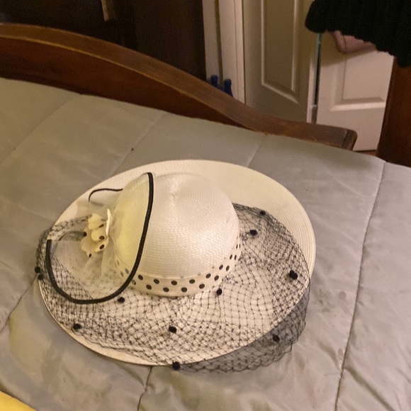 White hat polka dot netting over face net flower on side